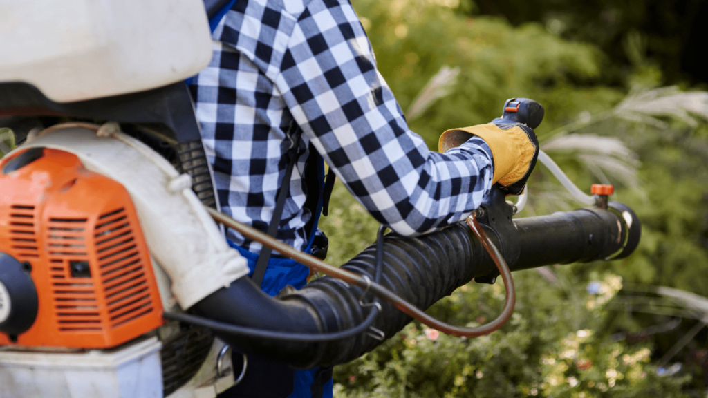 A guy using Leaf Blowers When Cleaning Gutters